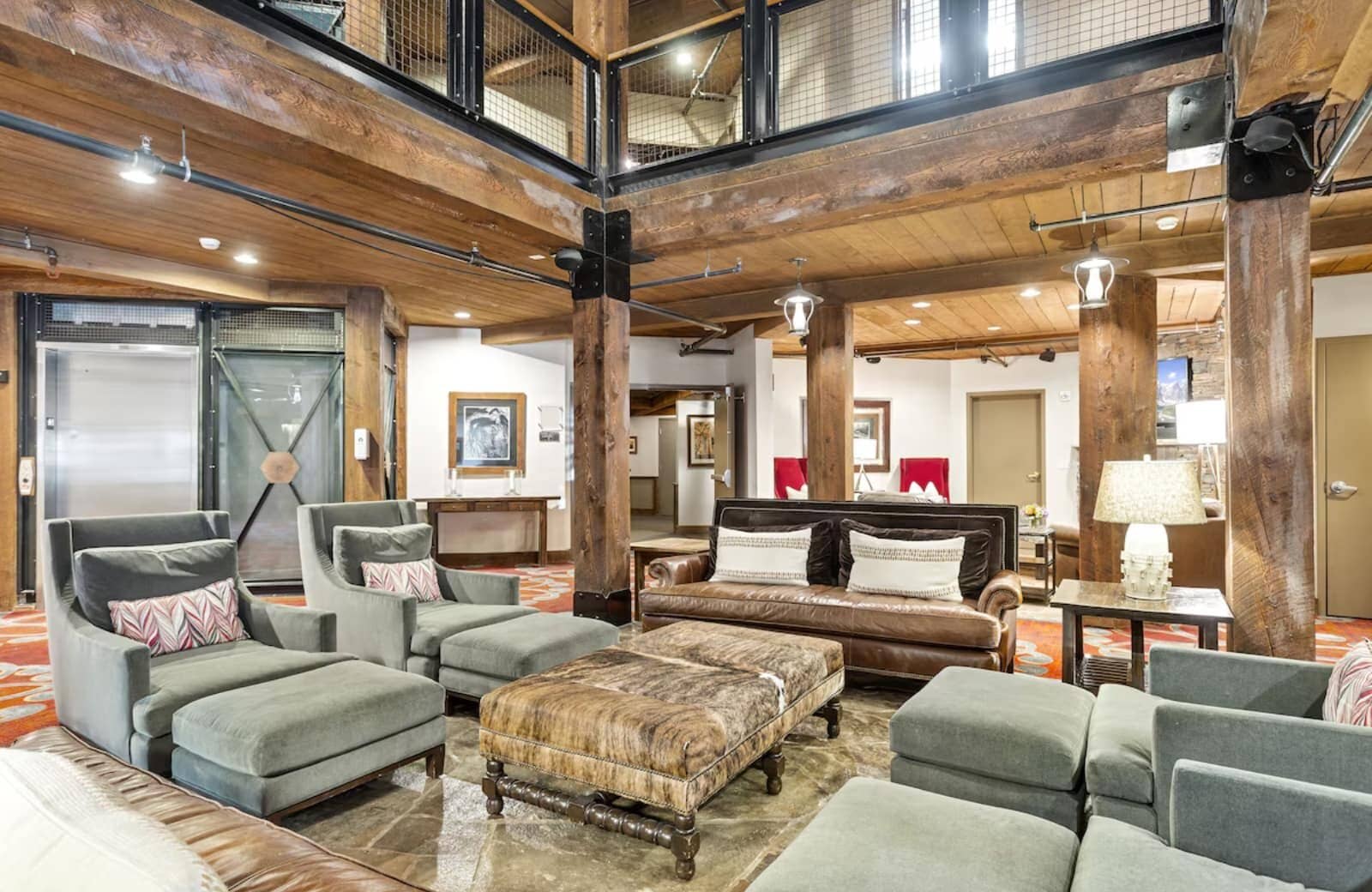 Shared lounge area featuring timber beams and elevator access