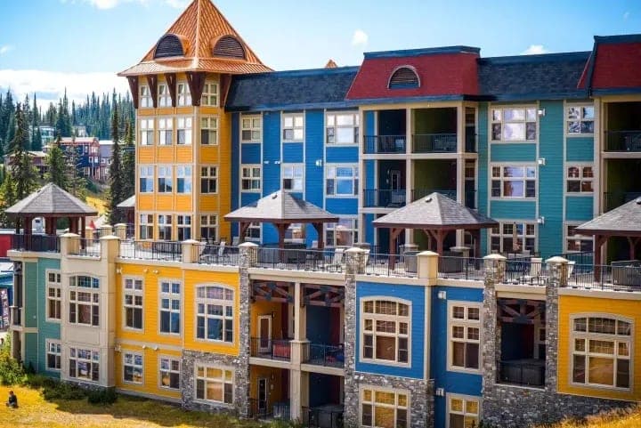 Lodge exterior featuring shared terrace with hot tubs and private balconies