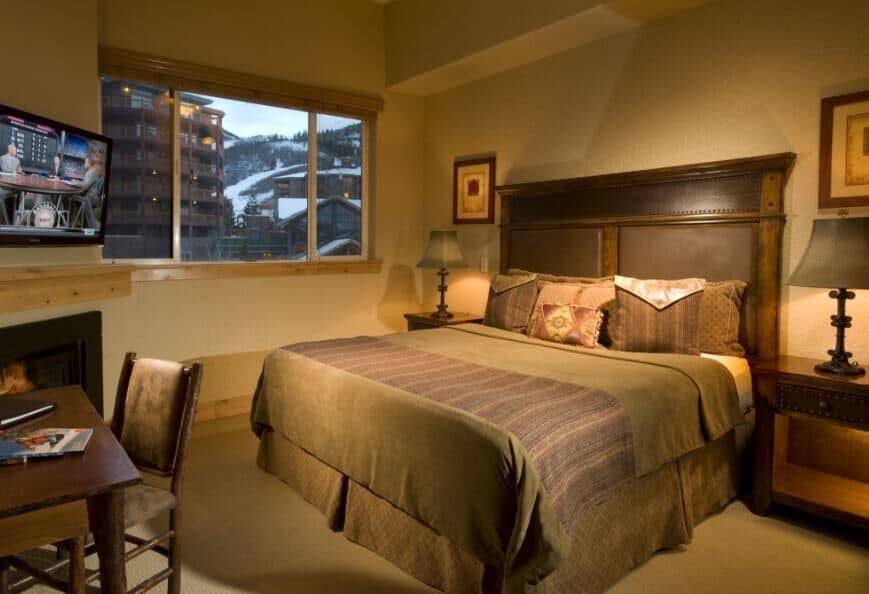 Primary bedroom with king bed, gas fireplace, and mountain views