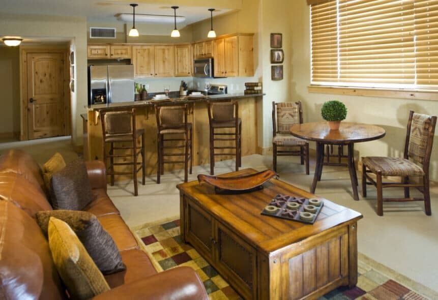 Open living area with breakfast bar seating for three and additional dining table