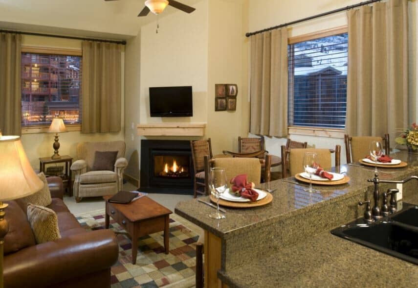 Open living area with gas fireplace and granite breakfast bar seating