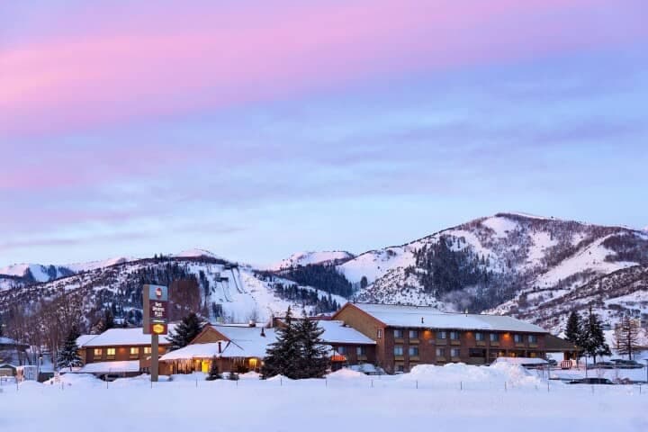 Hotel exterior with snow-covered grounds and nearby ski lift access