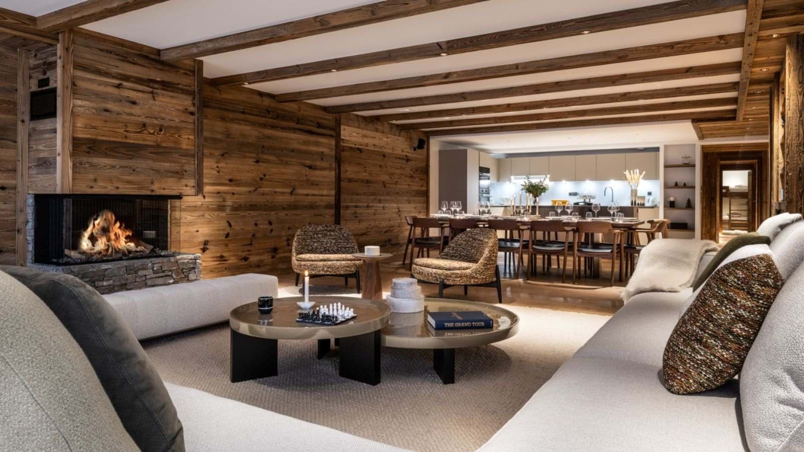 Open-plan living area with wood-burning fireplace and dining seating for 10