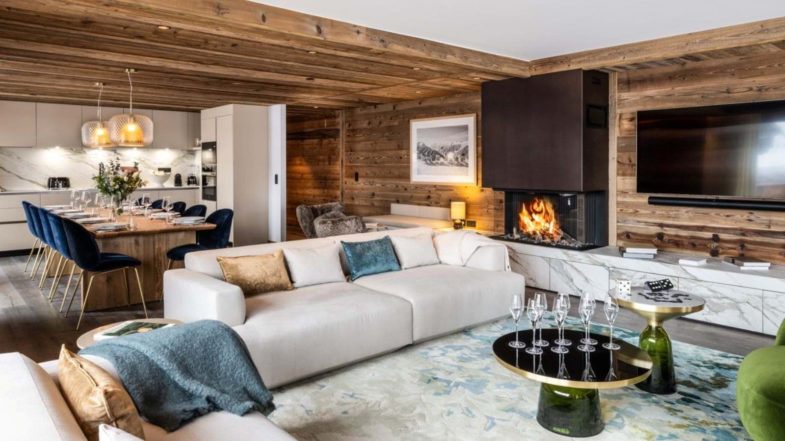 Open-plan living area with wood-burning fireplace and dining seating for 8