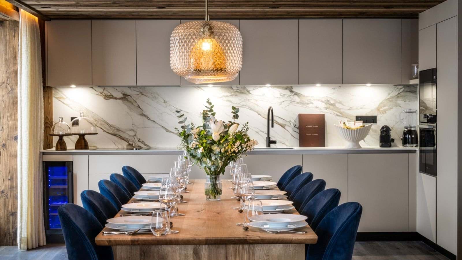 Dining table with seating for 10; kitchen features wine fridge and marble backsplash