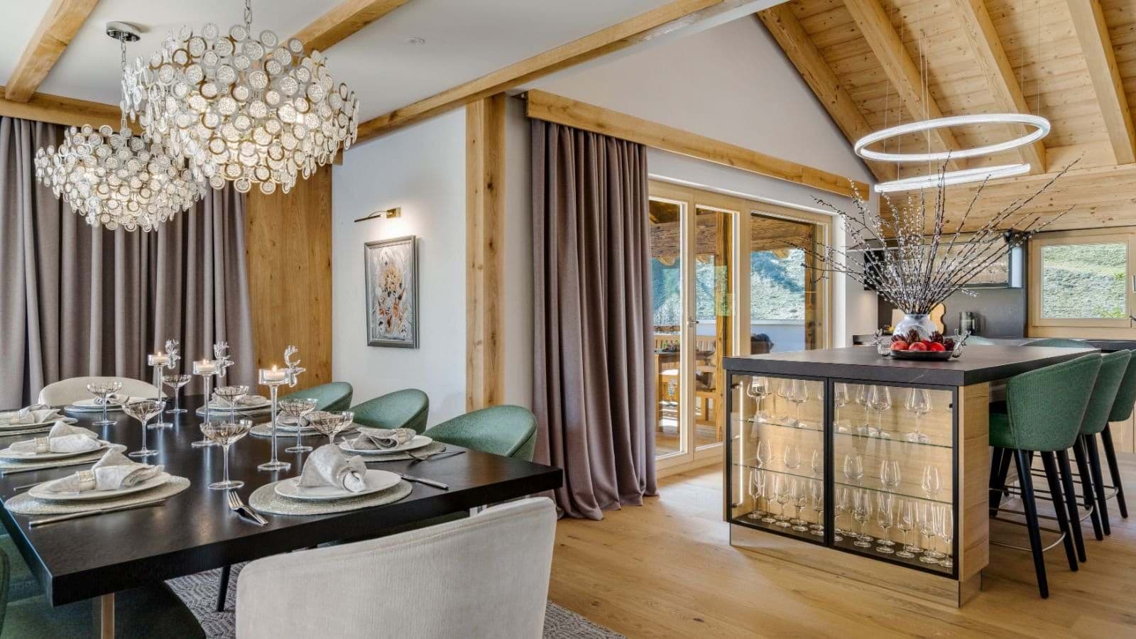 Dining area and kitchen island with integrated glassware storage and bar seating