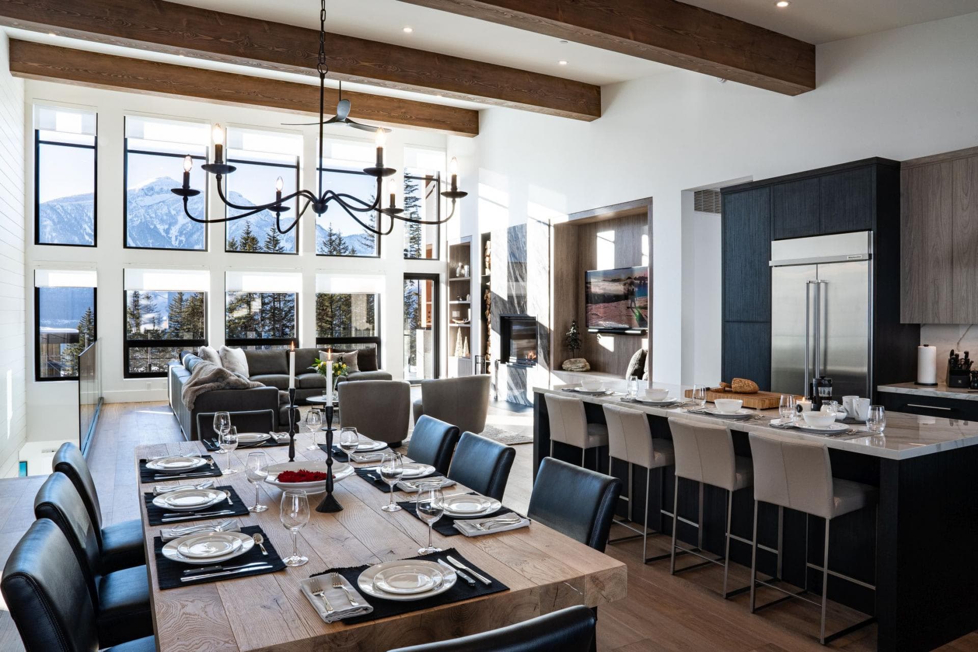 Open living area with dining for 8 and mountain-view floor-to-ceiling windows