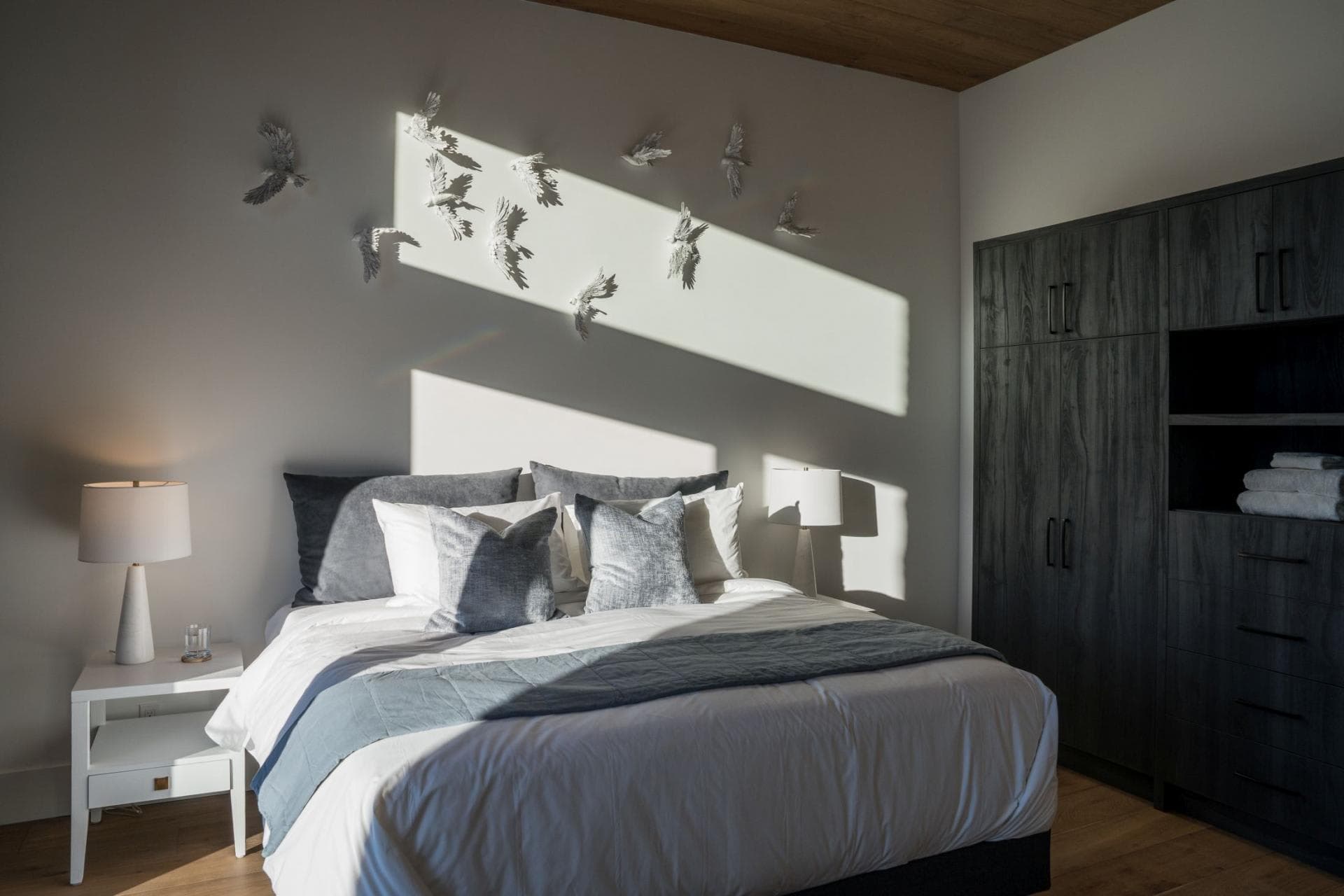 Guest bedroom with queen bed and built-in wardrobe storage