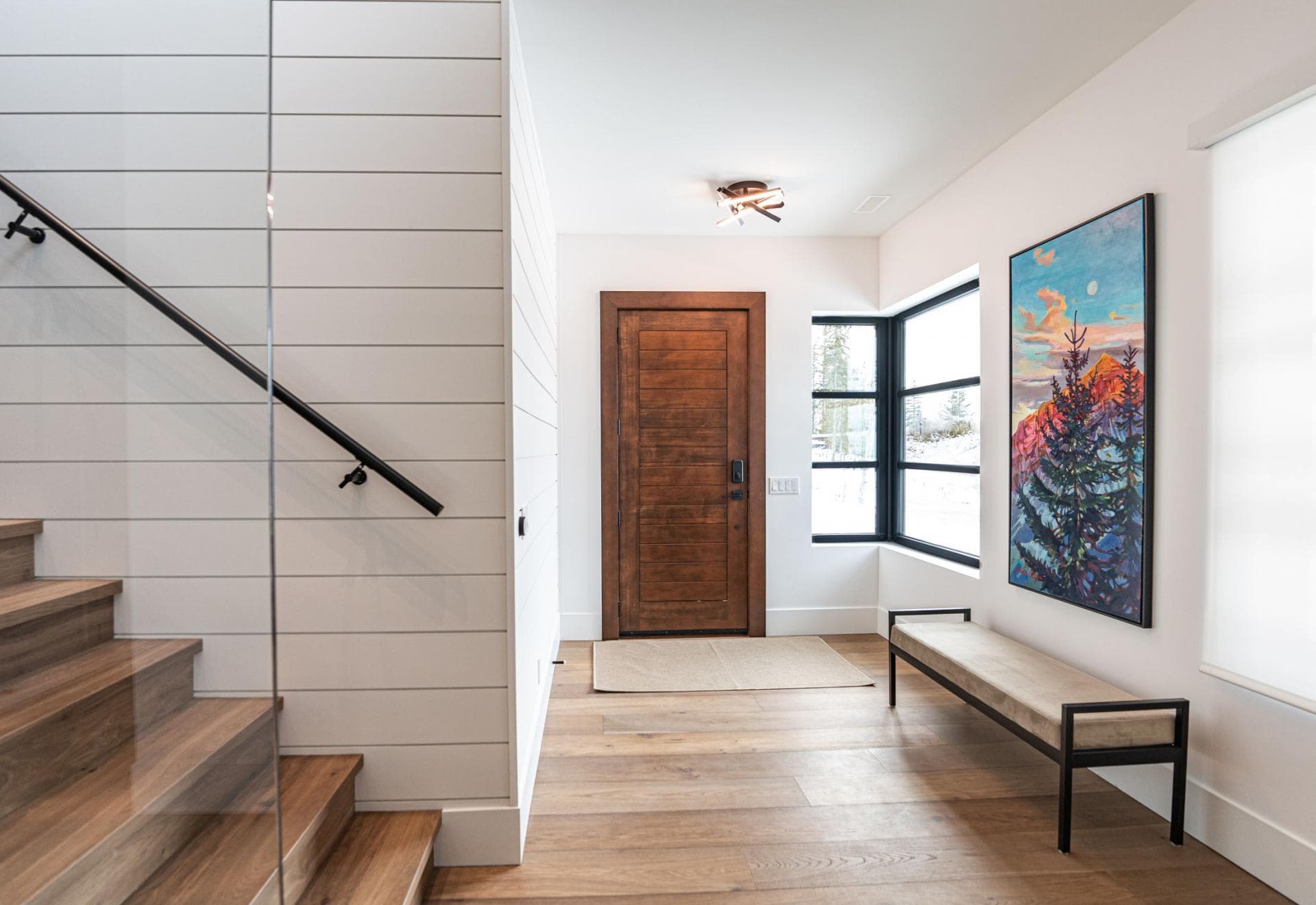 Foyer with bench seating, smart lock entry, and glass-walled staircase