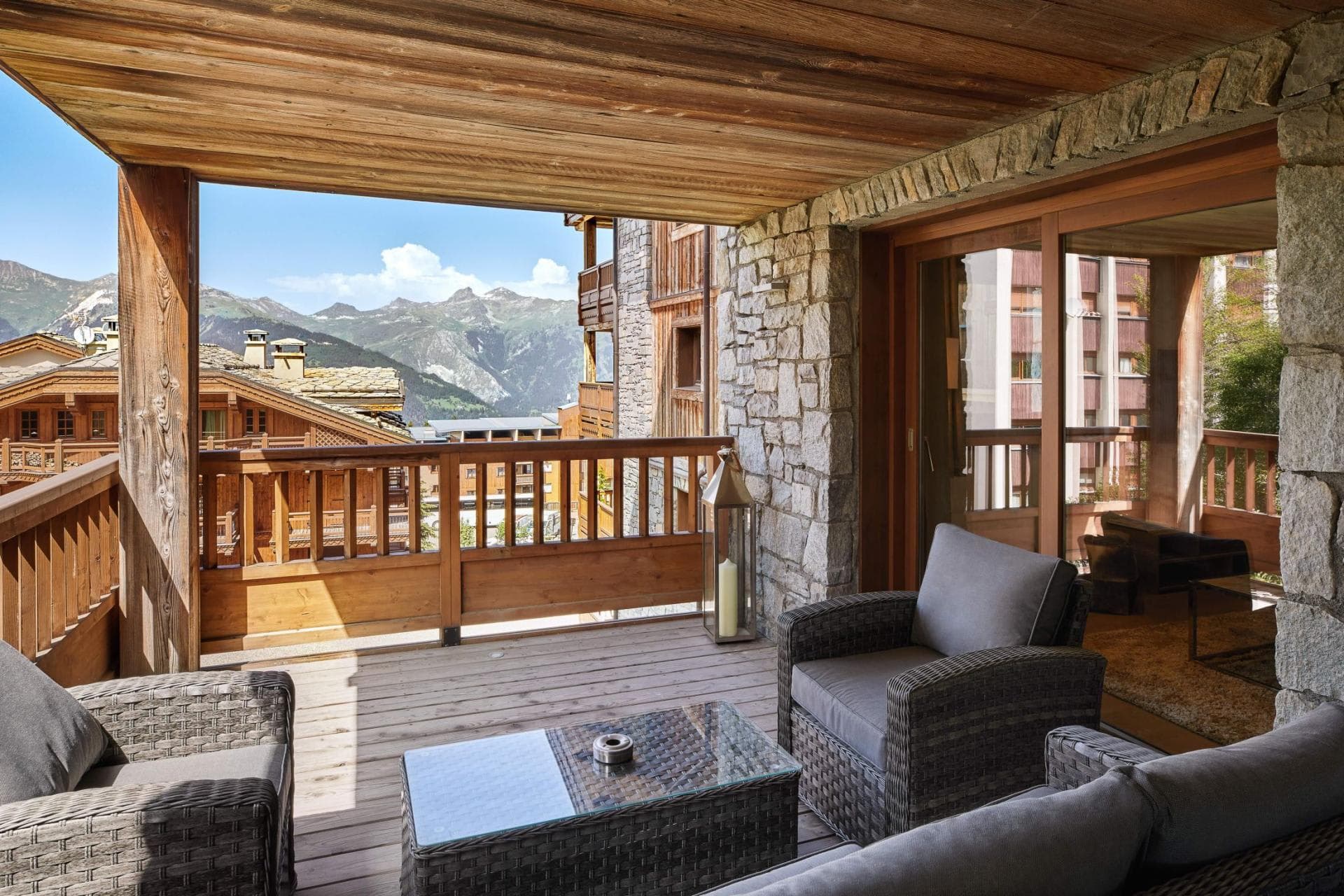 Covered terrace with lounge seating and alpine mountain views