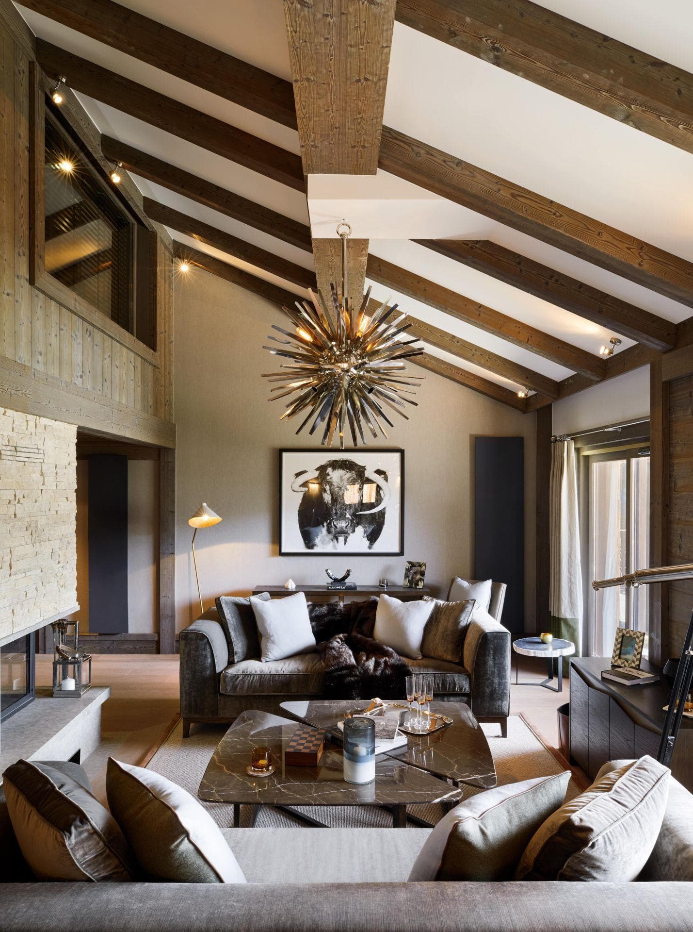 Living area with wood-beamed vaulted ceilings and stone fireplace