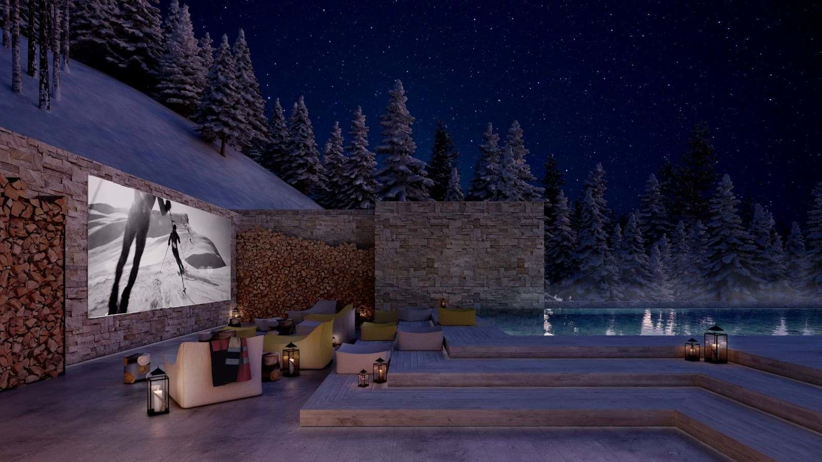 Outdoor cinema with large projection screen and tiered poolside lounge