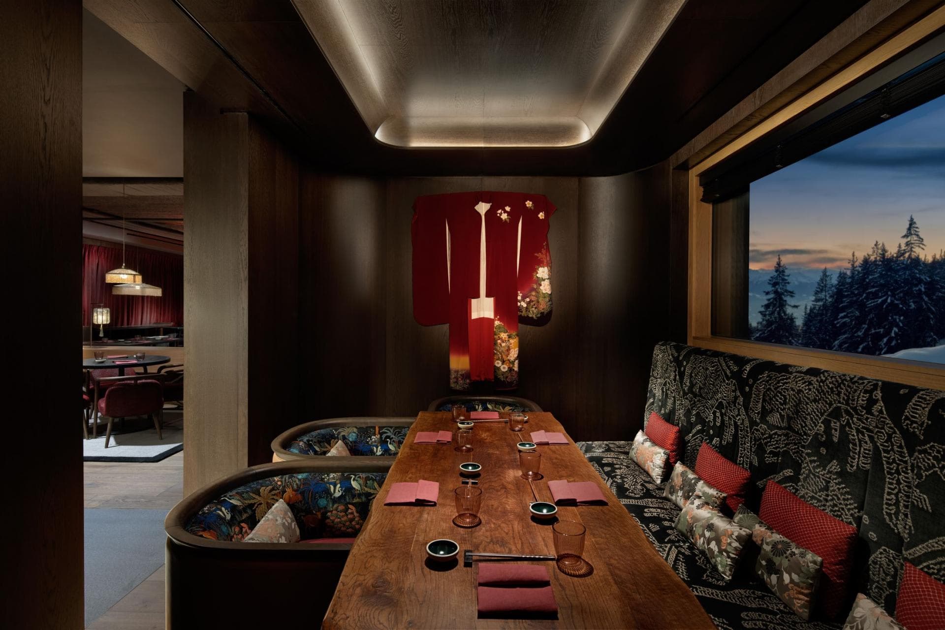 Private dining room with live-edge table and snowy mountain views