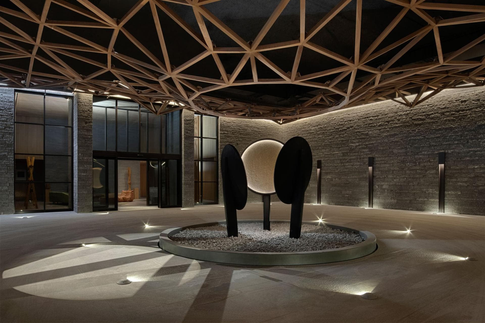 Entry foyer with geometric timber ceiling and central art installation