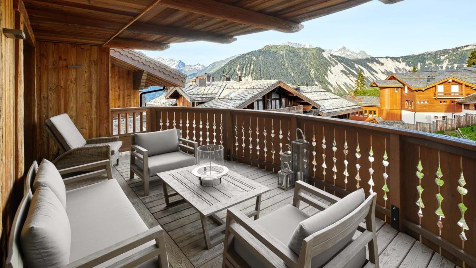 Covered private balcony with mountain views and lounge seating for 5