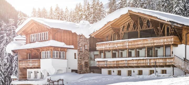 Ski-in/ski-out chalet with private balconies and mountain forest backdrop