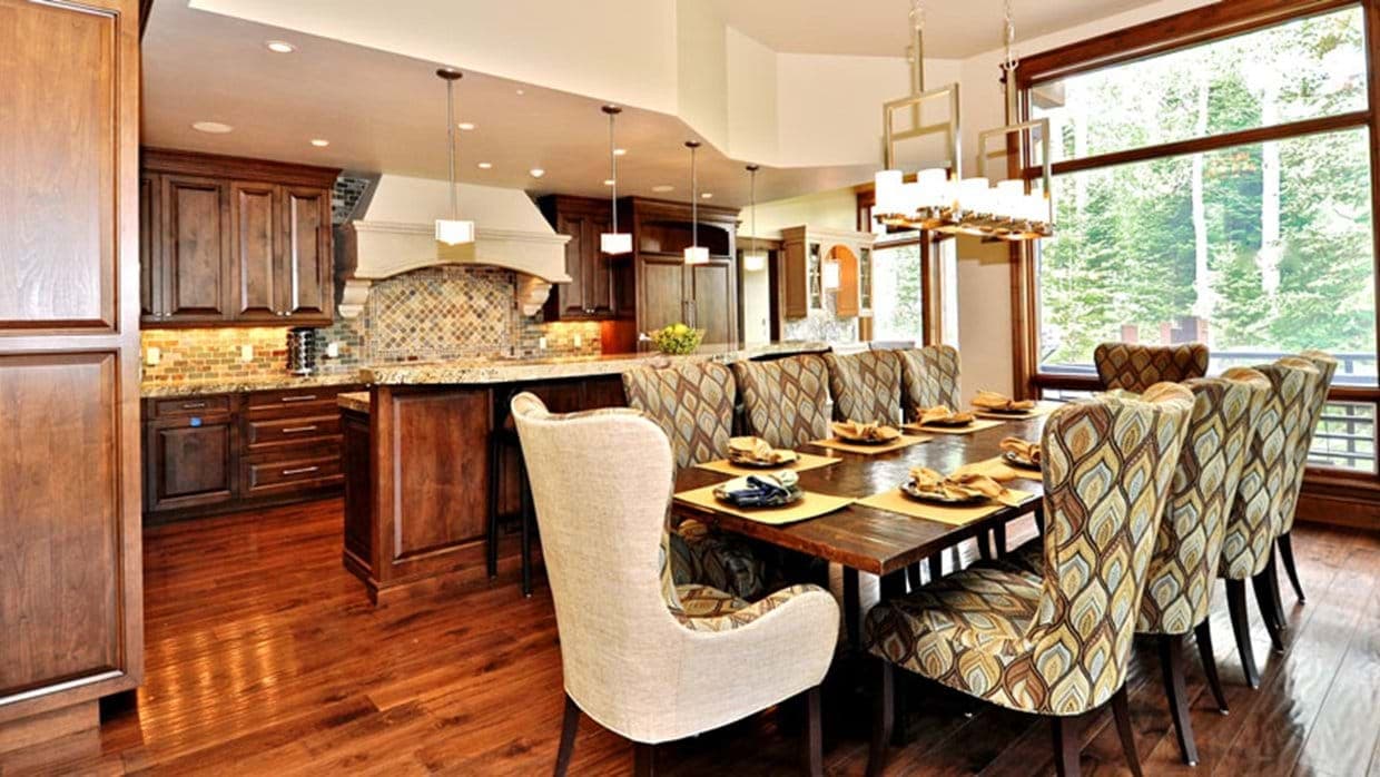 Dining table with seating for 8 adjacent to open kitchen