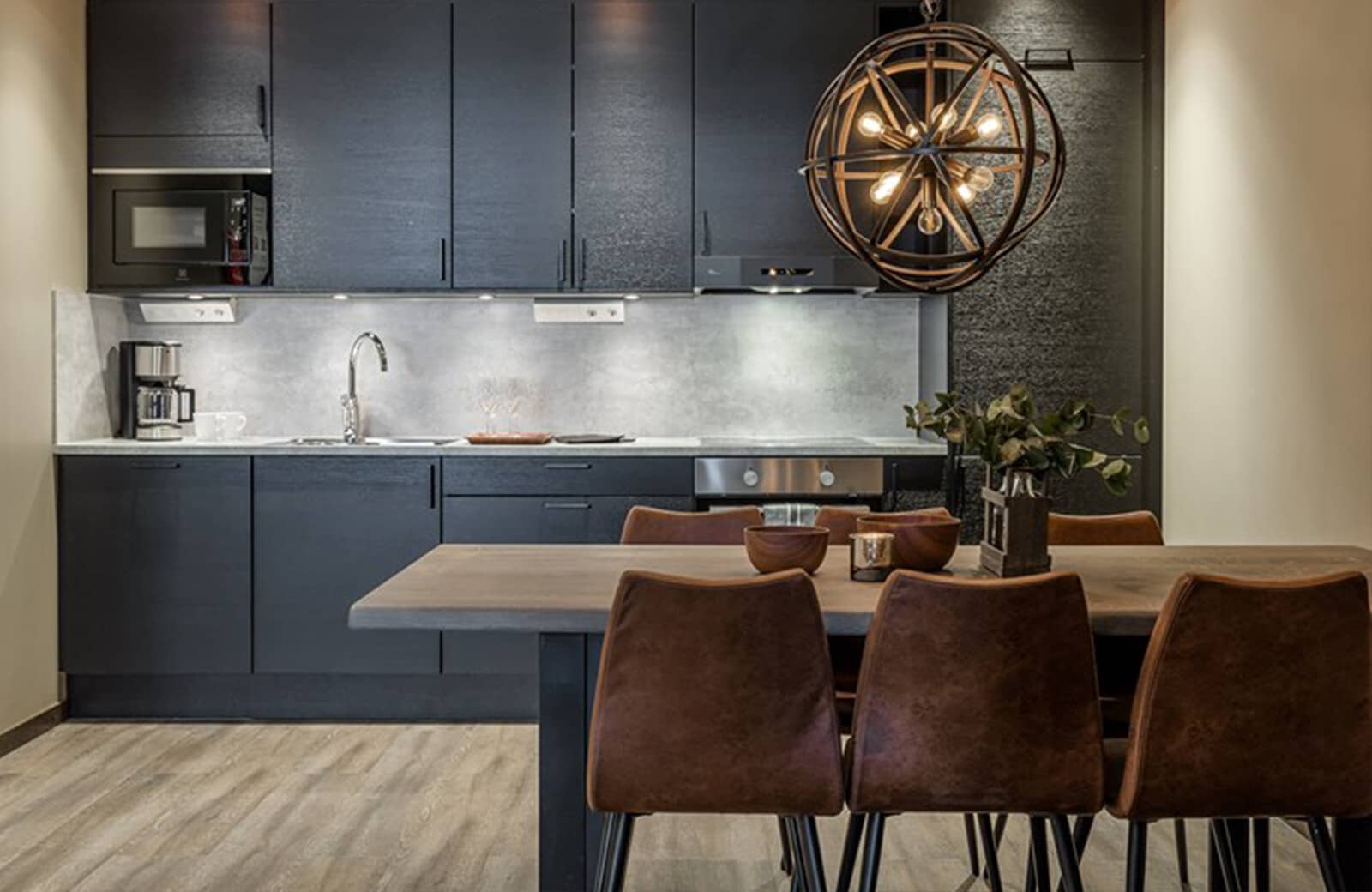 Kitchen with built-in microwave and dining table seating four