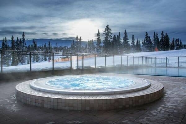 Outdoor heated whirlpool and pool with direct ski-in/ski-out mountain views