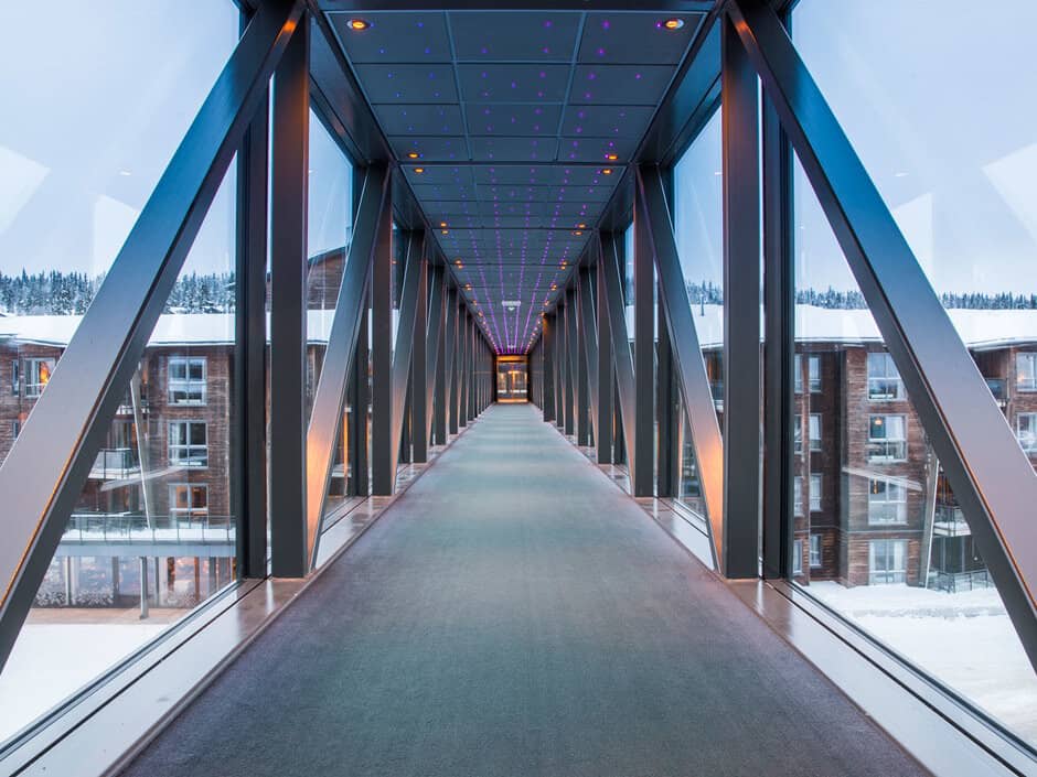Enclosed skybridge with floor-to-ceiling glass and star-effect LED ceiling lighting