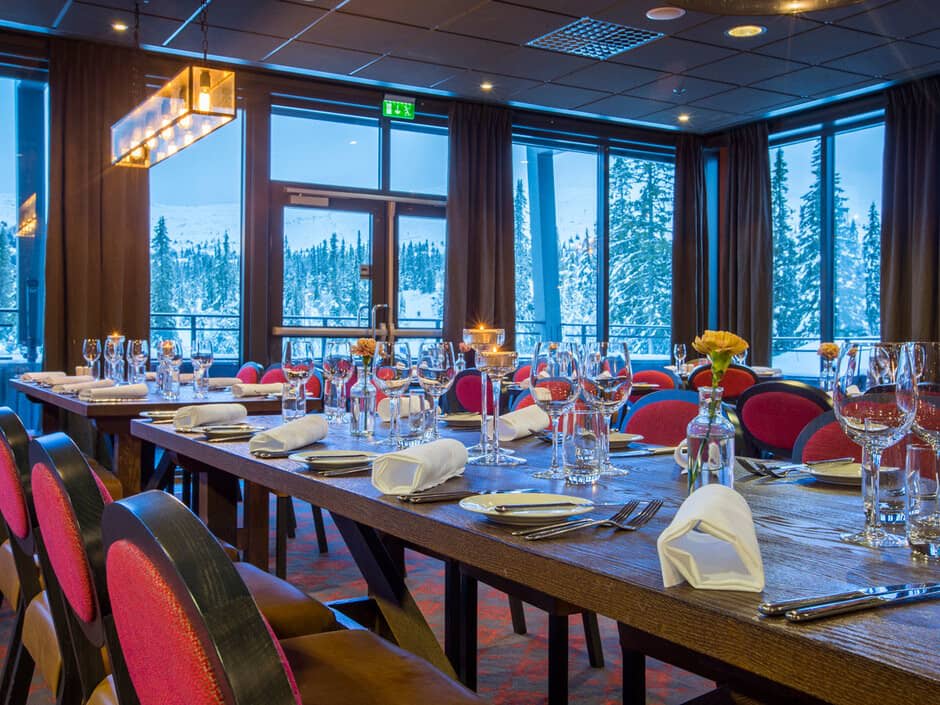 Dining room with large group seating and snow-covered mountain views