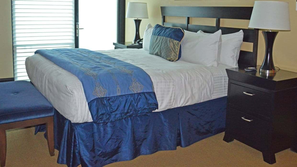 Primary bedroom with king bed and balcony access