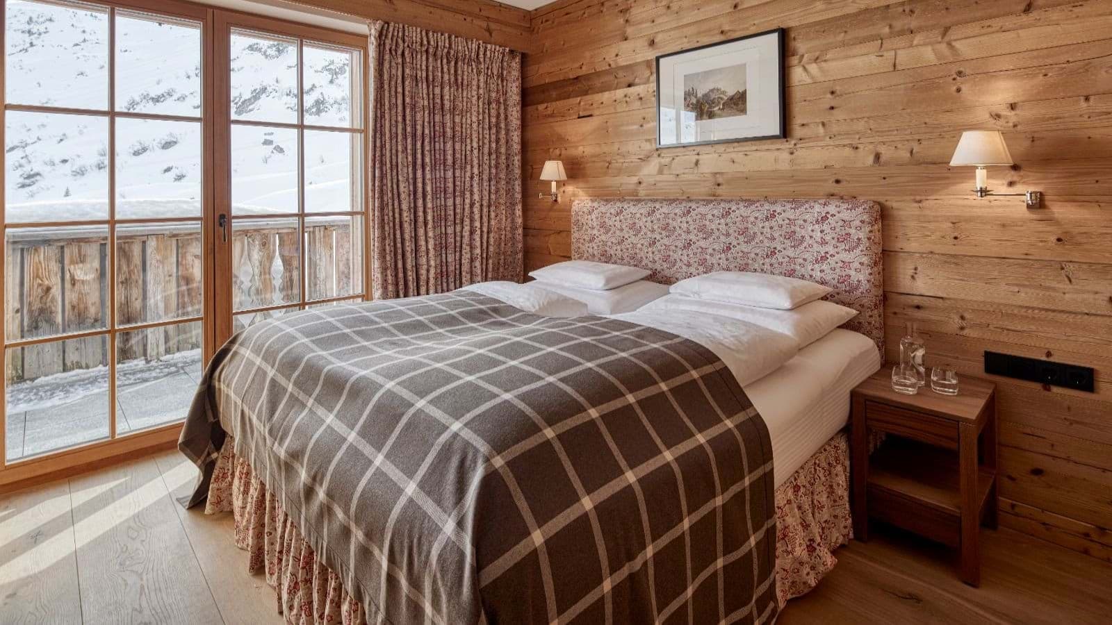 Bedroom with king bed and balcony access to mountain views