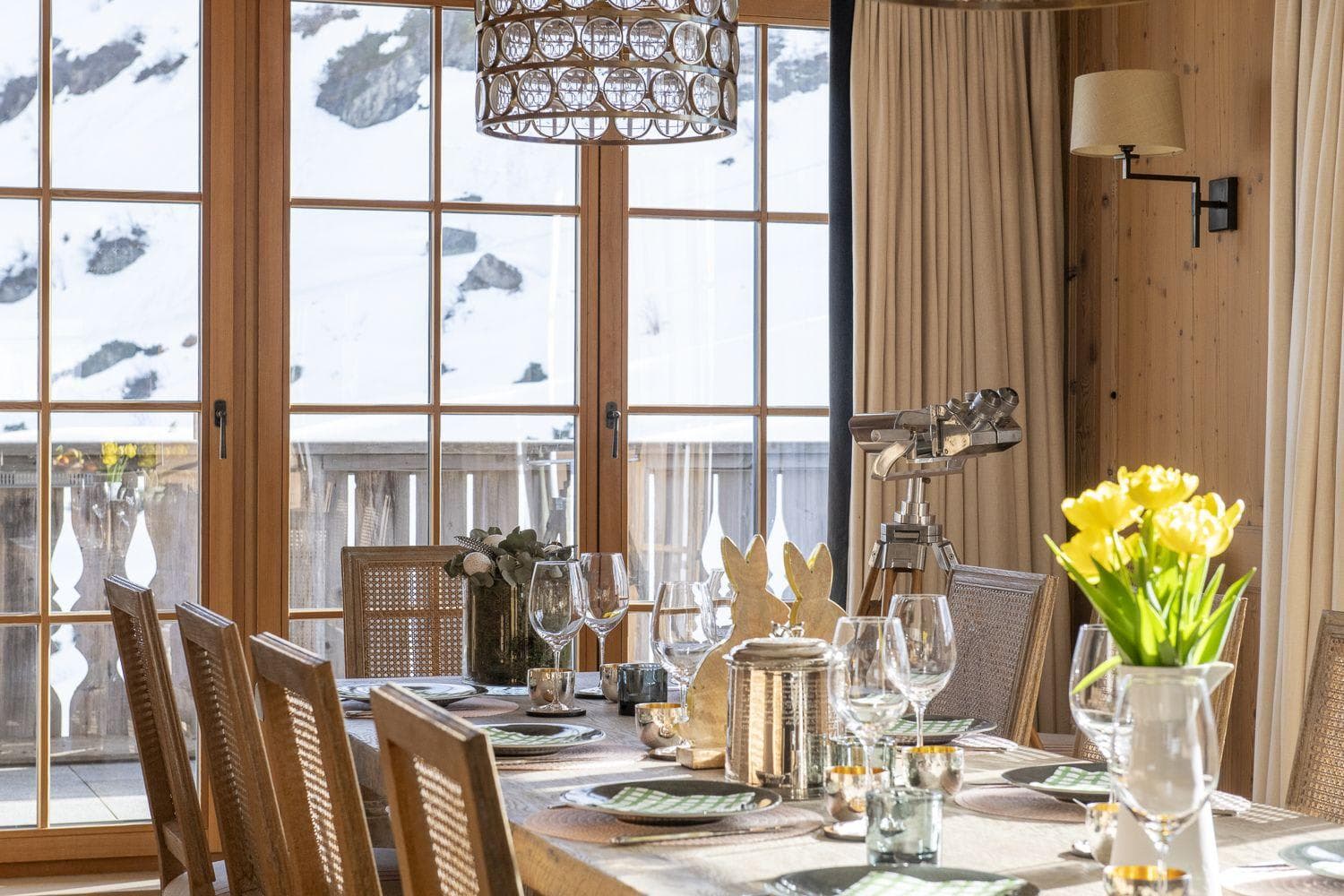 Dining area with snowy mountain views and balcony access