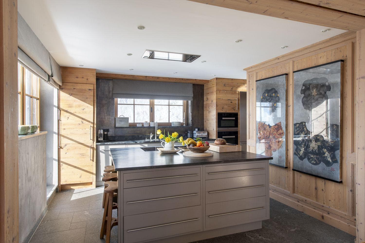 Kitchen island with breakfast bar seating and integrated double ovens