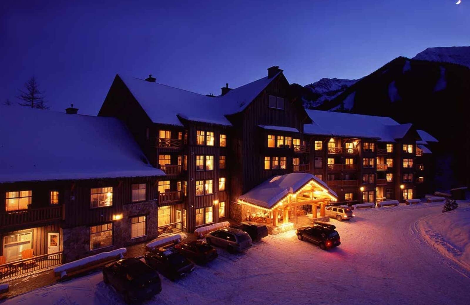 Ski-in lodge exterior with heated driveway and mountain access