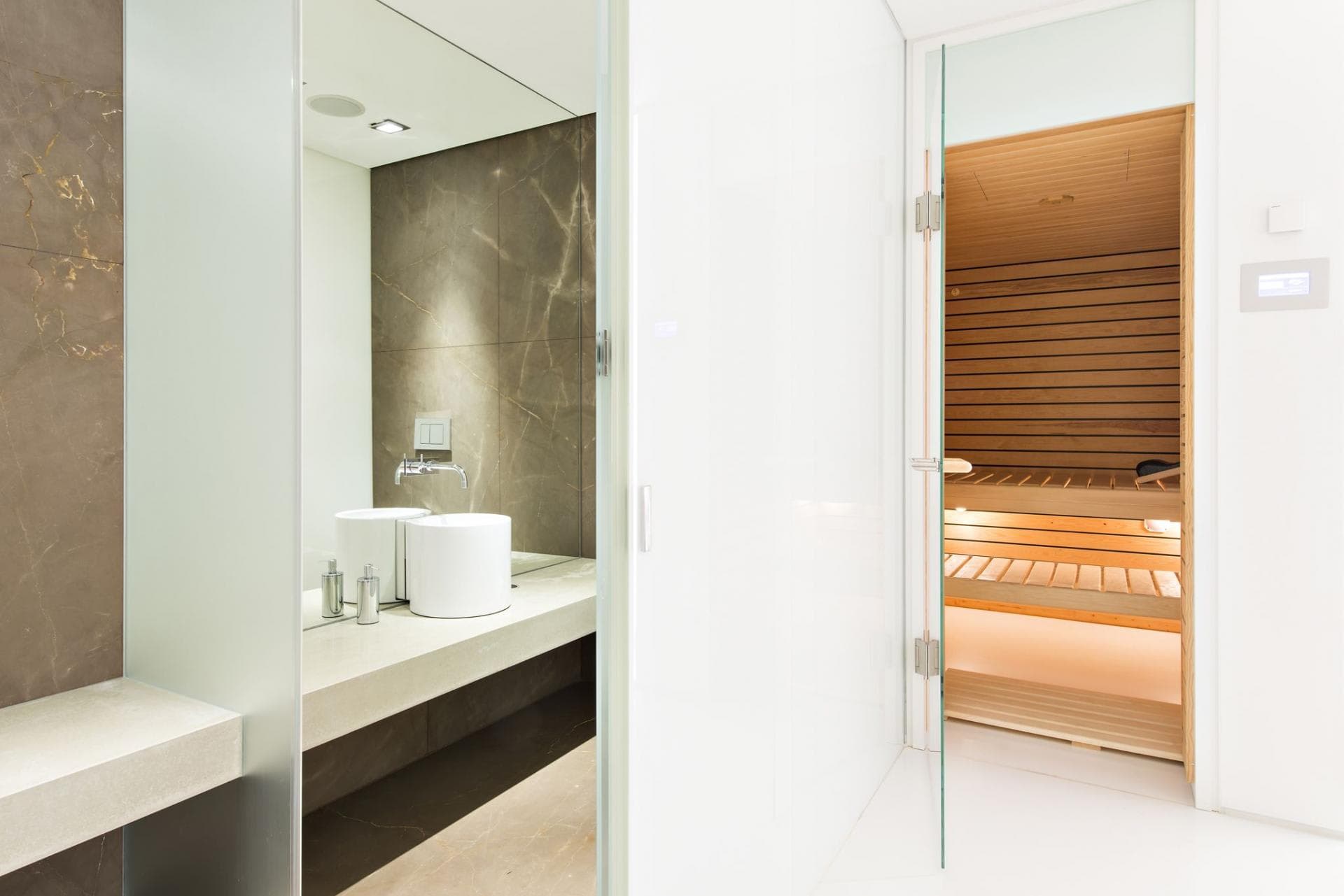 Bathroom with private wood-paneled sauna and stone vanity