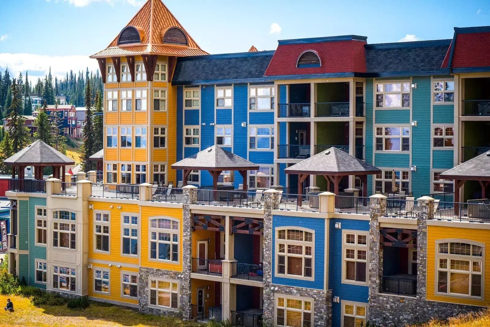 Building exterior featuring private balconies and shared terrace with hot tubs