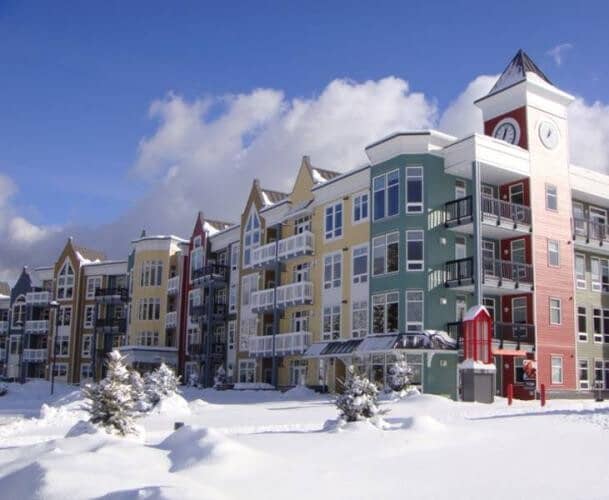 Ski-in/ski-out lodge exterior with private balconies and clock tower