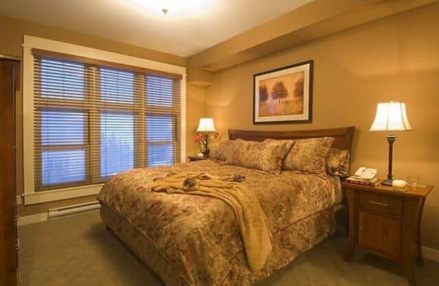 Guest bedroom with queen bed and blackout window blinds