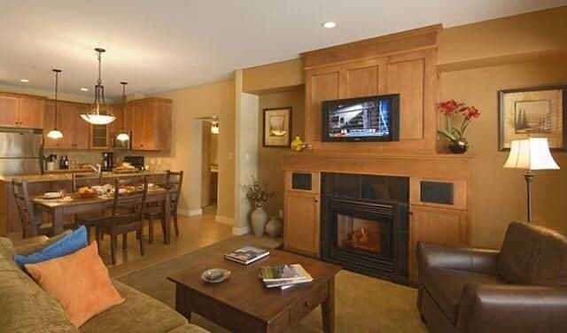 Open living area with gas fireplace and dining table for six