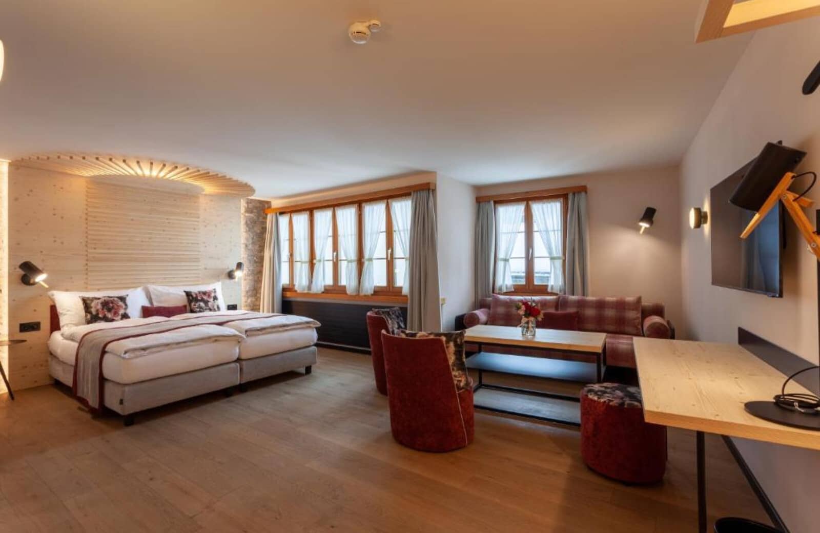 Studio suite with twin beds, dedicated workspace, and separate seating area