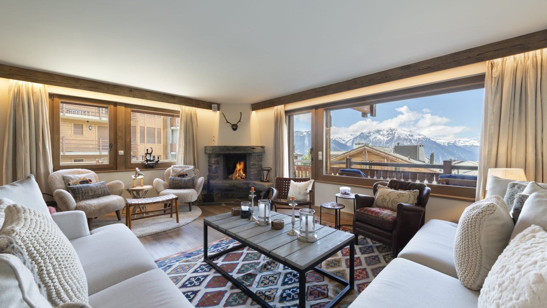 Living area with wood-burning fireplace and panoramic mountain views