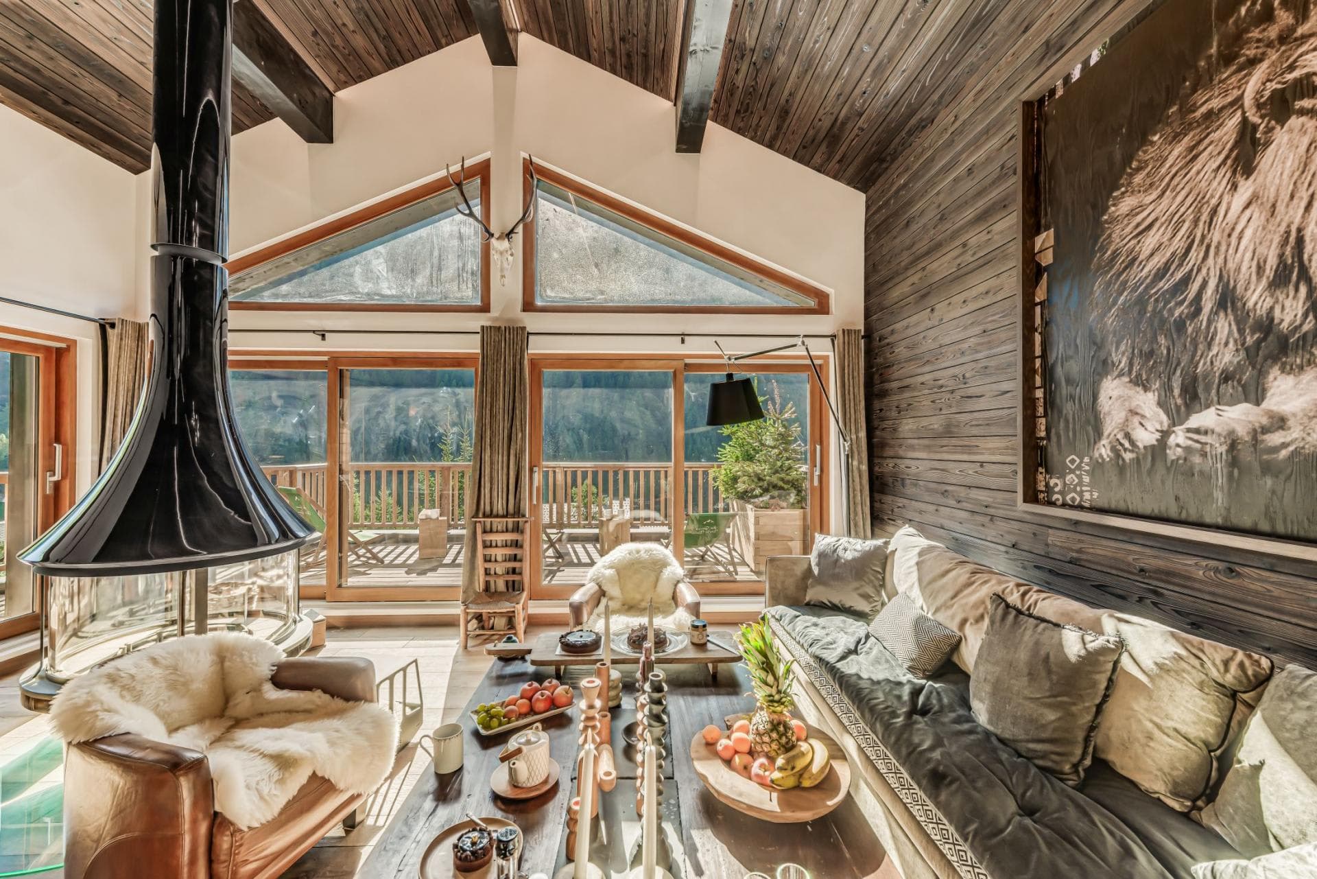 Living area with central wood-burning fireplace and private deck access