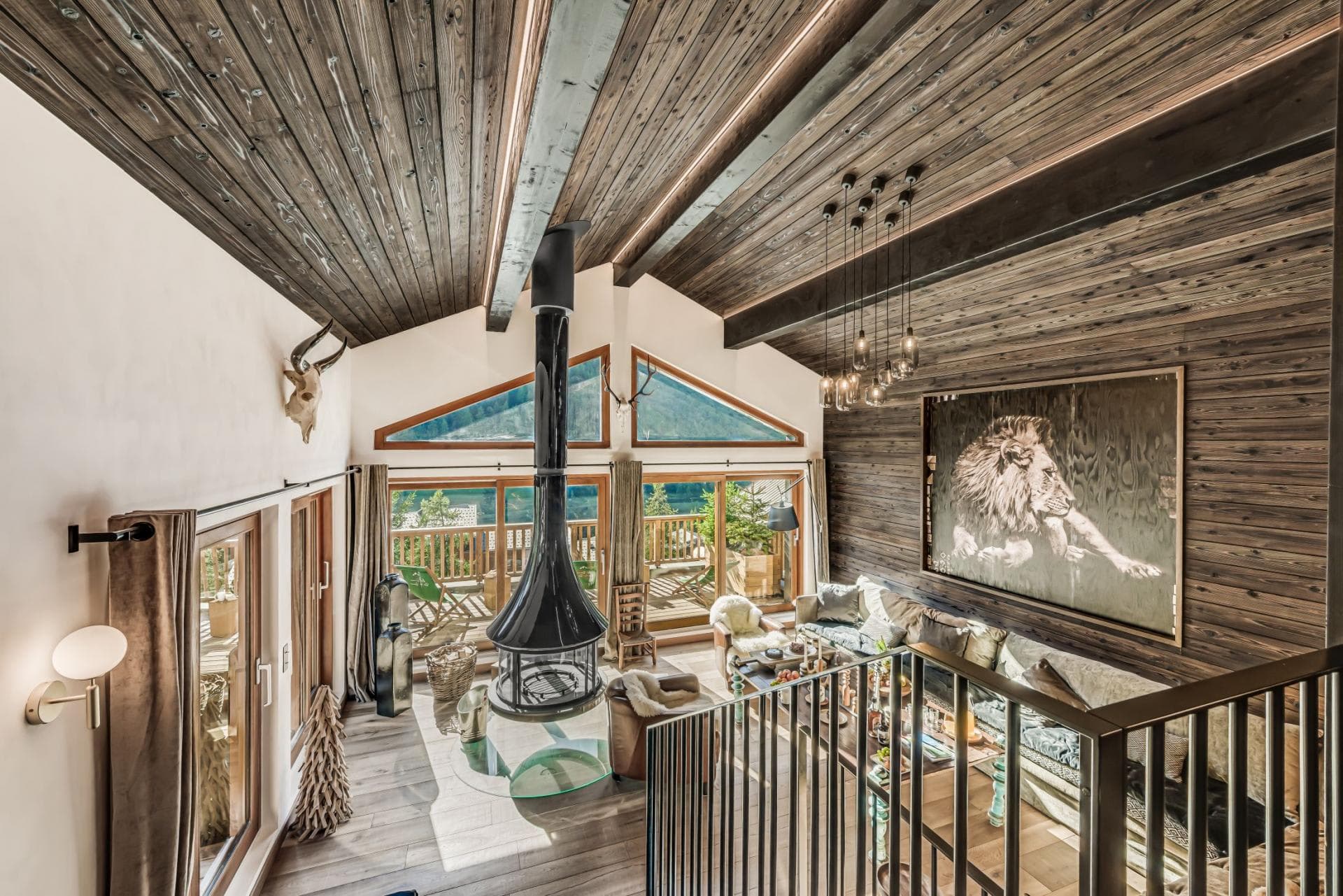 Living room featuring central suspended fireplace and mountain views