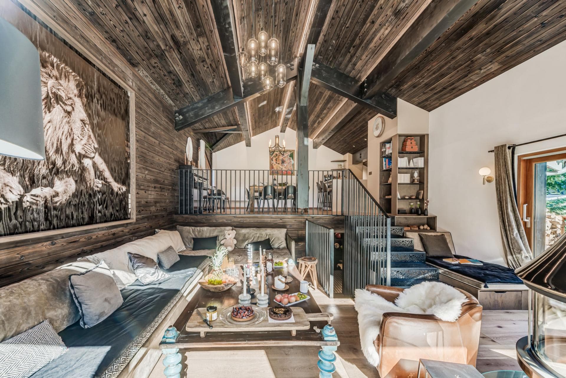 Split-level living room with built-in sectional and vaulted wood ceilings