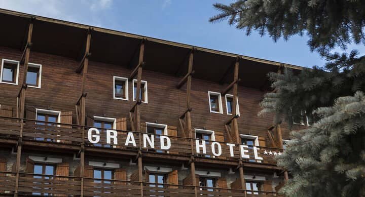 Timber facade of Grand Hotel with private balconies and window shutters