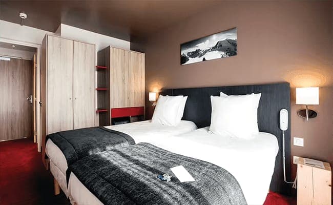 Guest bedroom with two twin beds and wardrobe storage