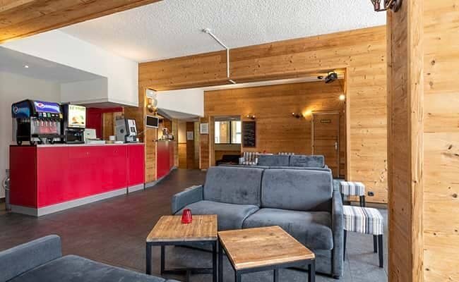 Shared lounge area with sofa seating and self-service beverage station