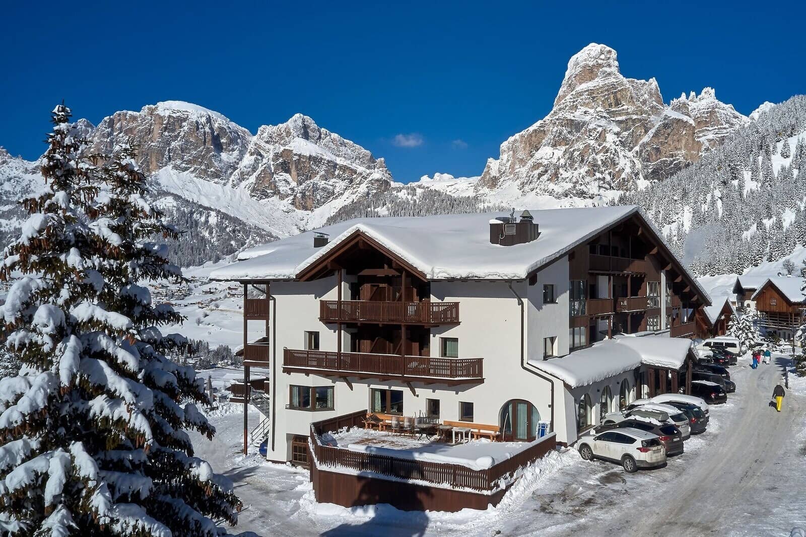 Ski chalet exterior with private balconies and on-site parking area