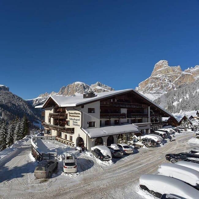 Ski-in exterior with on-site parking and Dolomite mountain views