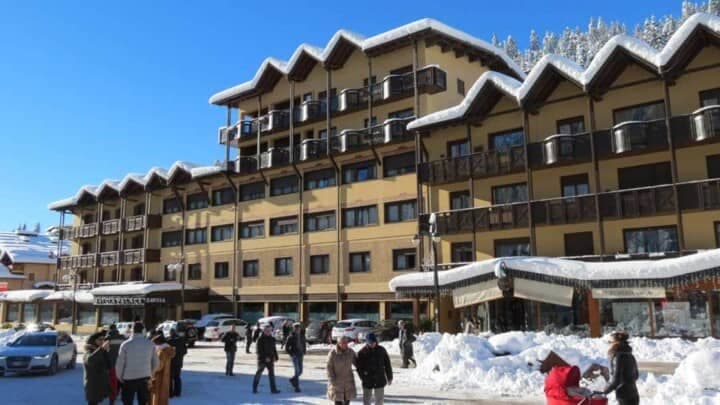 Ski-in lodge exterior with private balconies and ground-floor boutique shops
