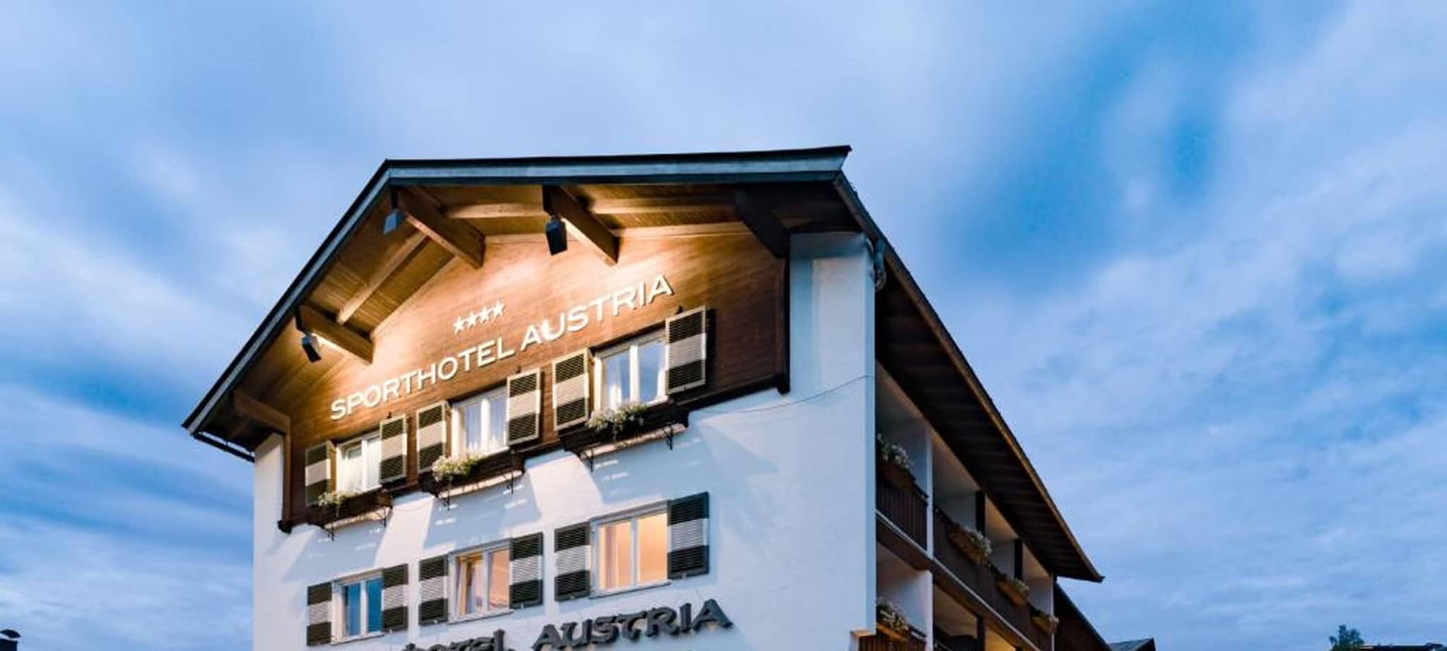 Hotel exterior with private balconies and traditional Austrian wood gables