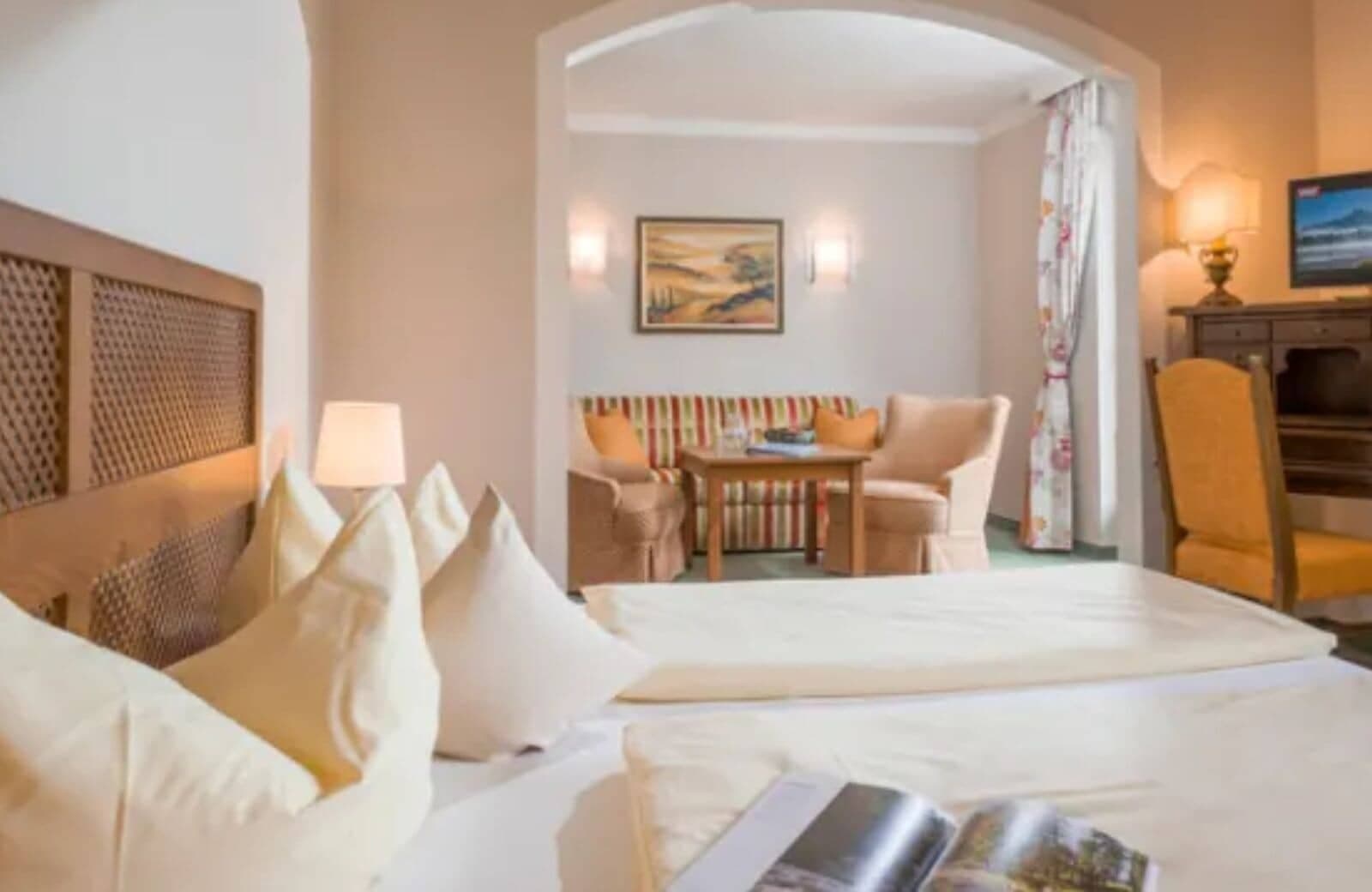 Guest suite with king bed, dedicated workspace, and separate sitting area