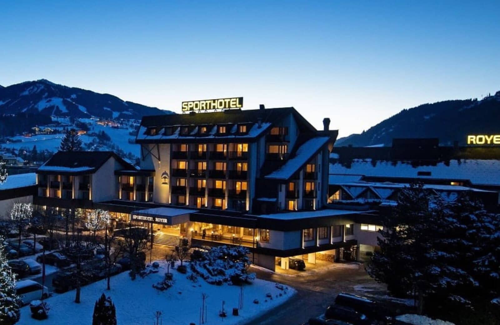 Hotel exterior at dusk; private balconies with mountain and valley views