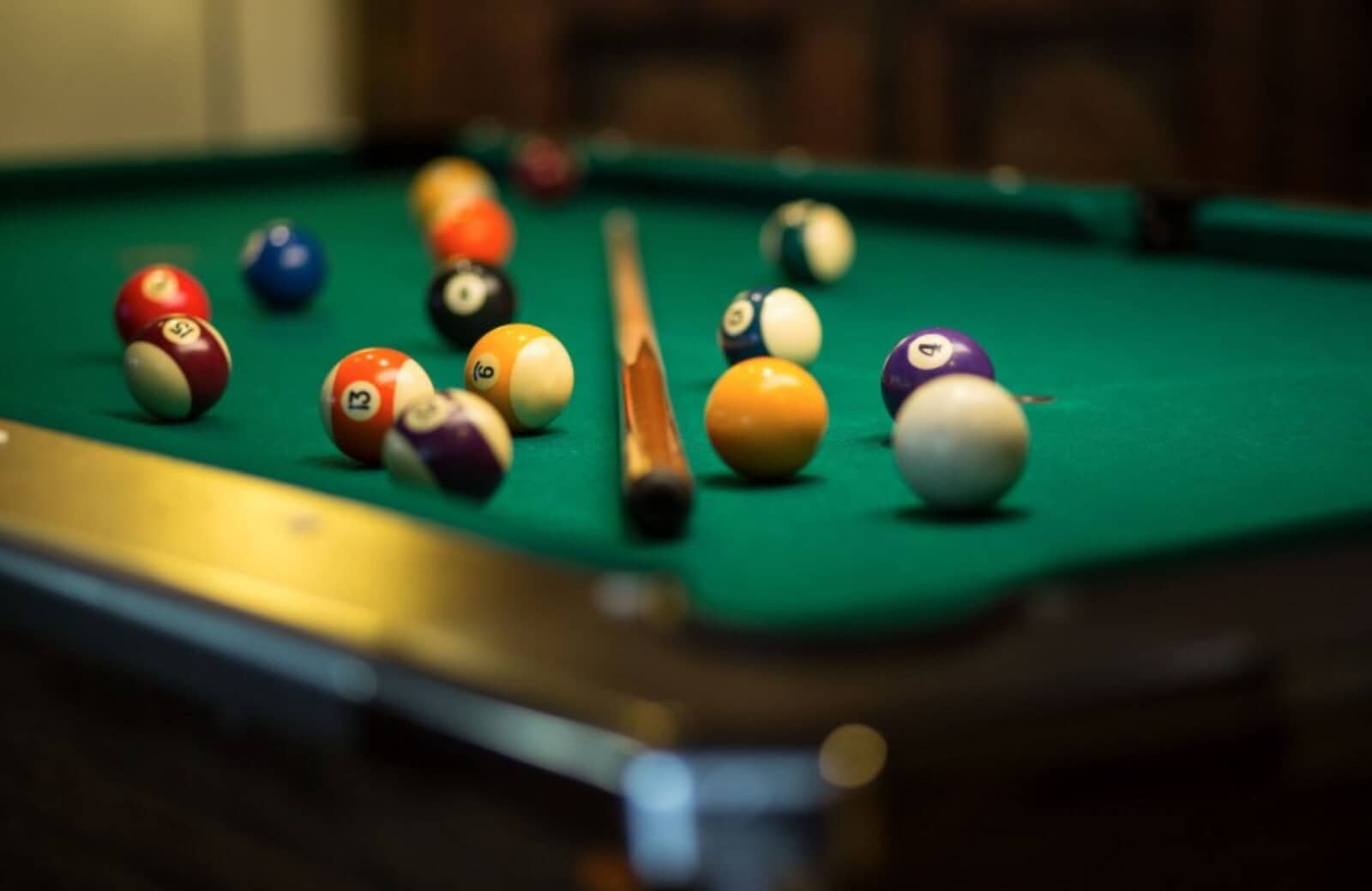 Game room featuring full-size pool table with felt surface and cues